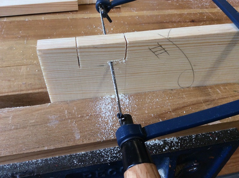 close up of sawing a finger joint on pine