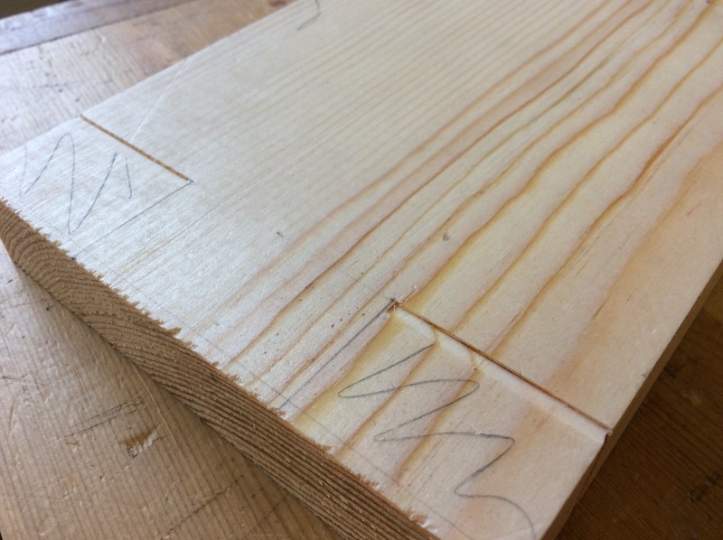 knife wall close up on pine plank