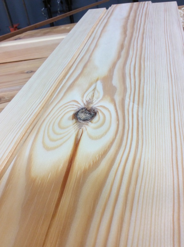 planed pine plank with ace-of-spades-shaped knot